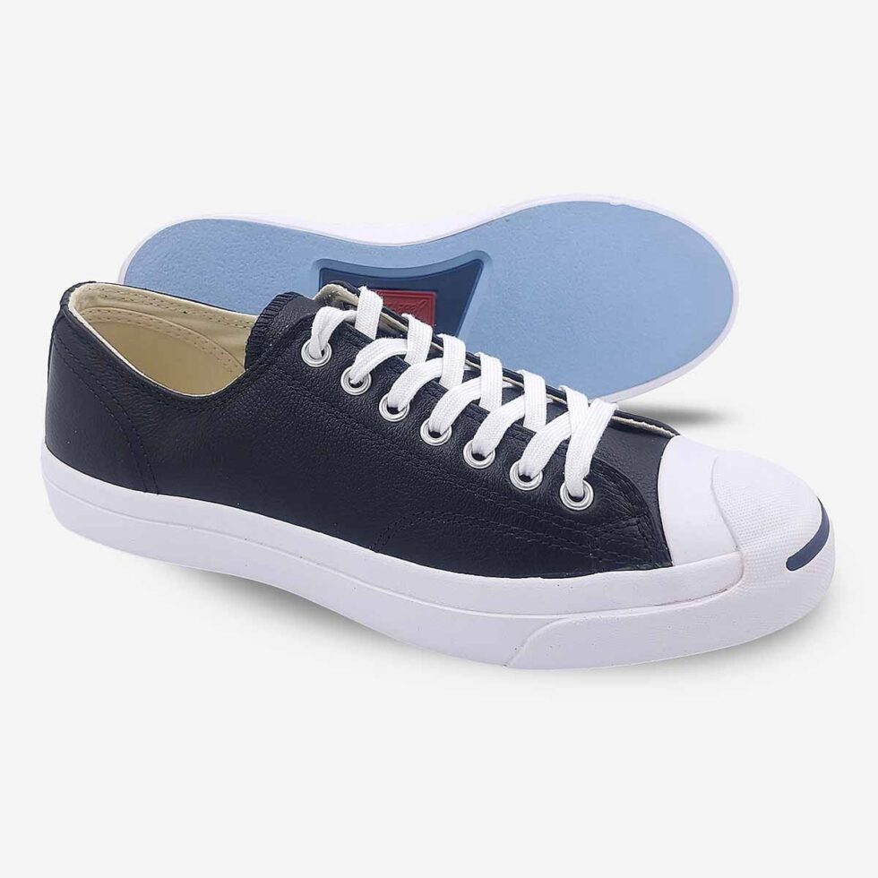 Side-bottom angle of Jack Purcell low black leather sneaker showing blue sole underneath