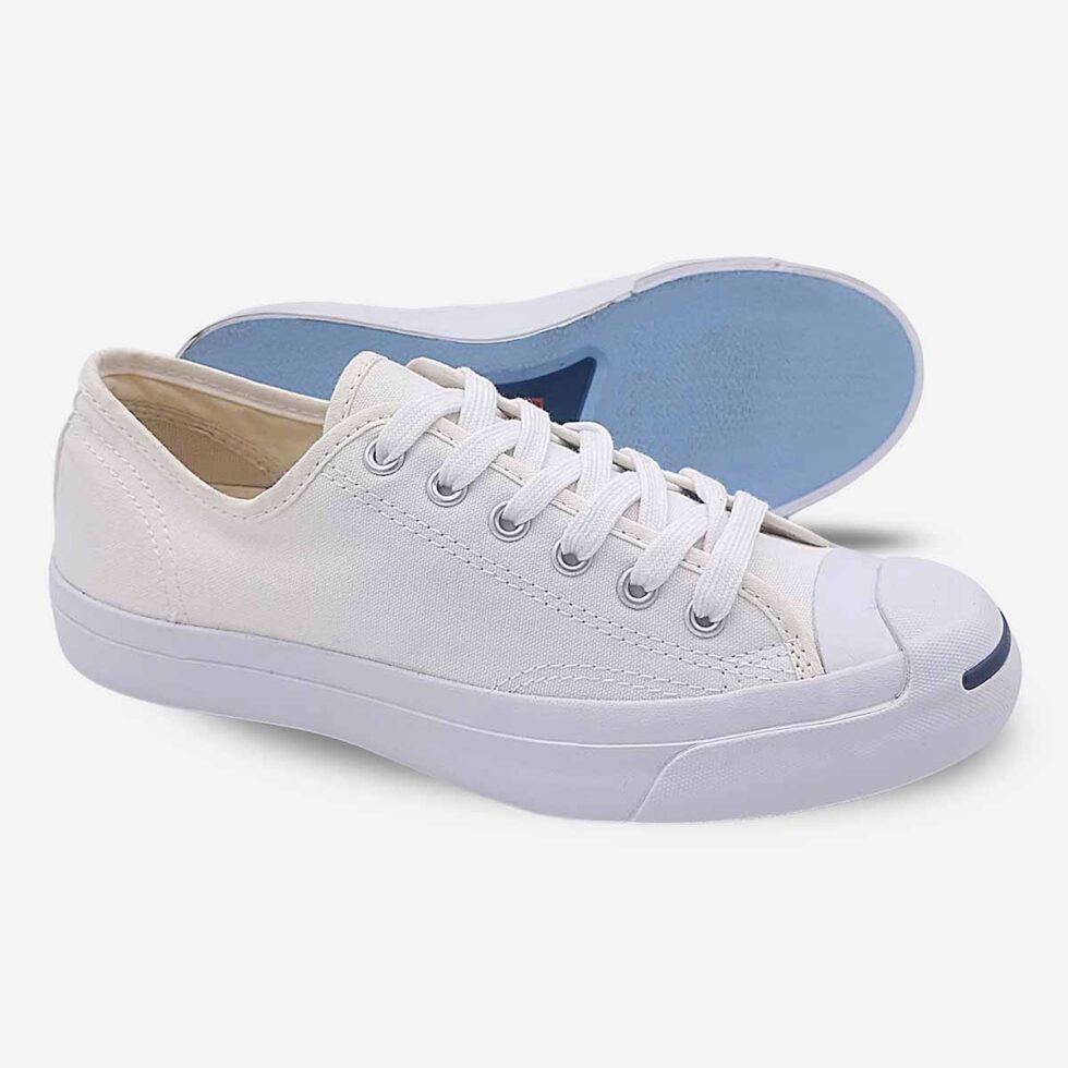Side-bottom angle of Jack Purcell white canvas low-top showcasing the blue rubber outsole