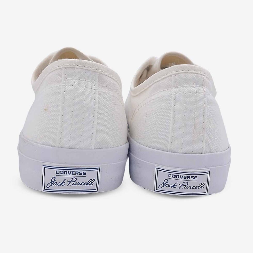 Back view of Jack Purcell low white canvas sneaker with heel branding and blue sole