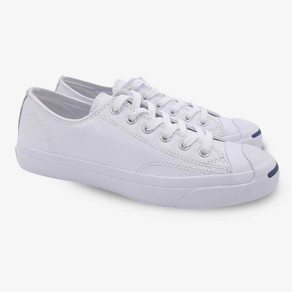 Angled pair of Jack Purcell white leather low-top sneakers with blue sole underside