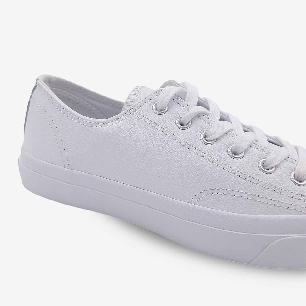 Close-up of Jack Purcell low white leather sneaker showing smooth white leather and stitch detailing