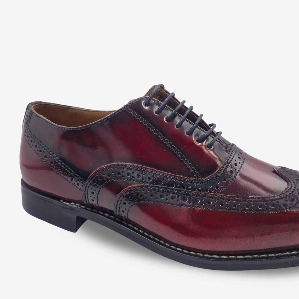 Up-close view of Bishop Oxford Shoes in burgundy maroon colour with wingtip brogue and medallion toe.