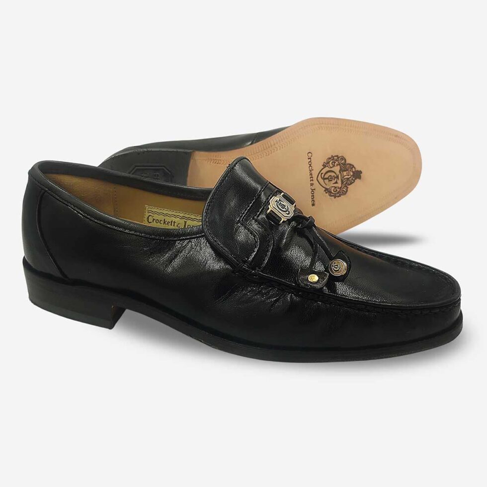 Crockett & Jones Glace Kid Black tassel loafers angled showing leather soles and Goodyear construction