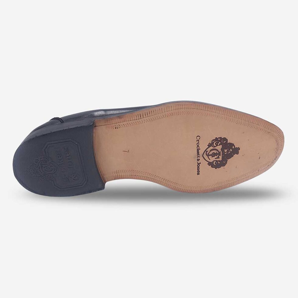 Sole of Crockett & Jones Glace Kid Black tassel loafers with embossed logo and leather soles
