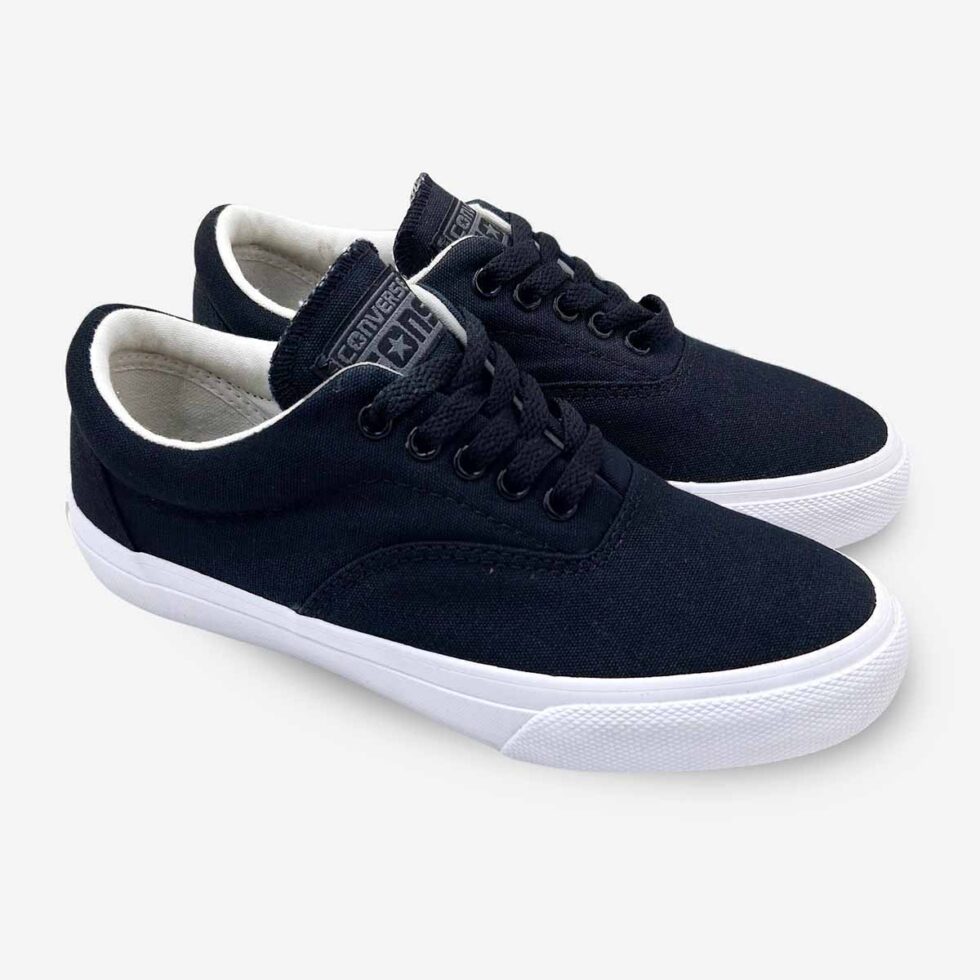 Angled pair of Converse Skidgrip black low sneakers in canvas with lace-up design