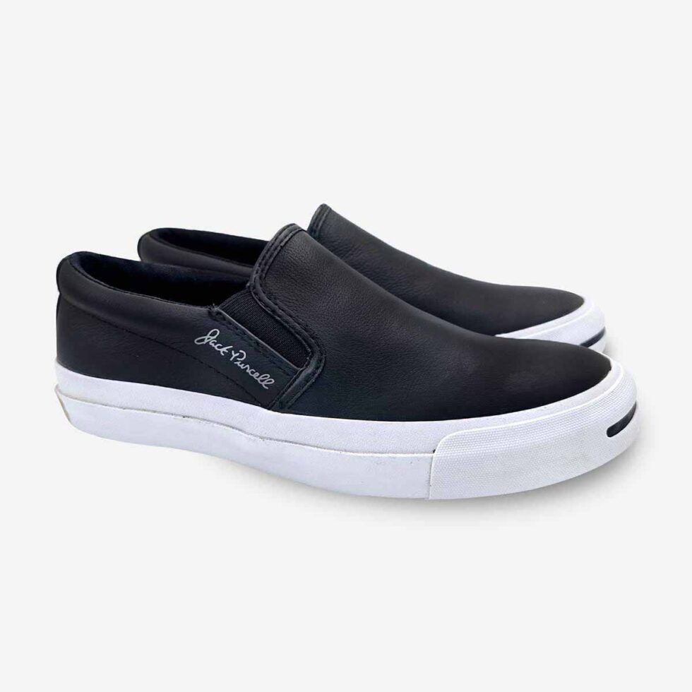 Angled pair of Jack Purcell leather slip-on sneakers for men in black colour