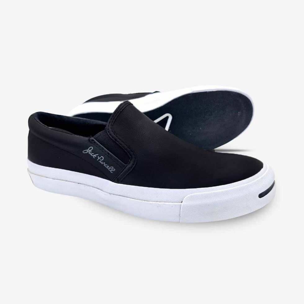 Angled view of Jack Purcell men’s black colour leather slip-ons with black rubber sole