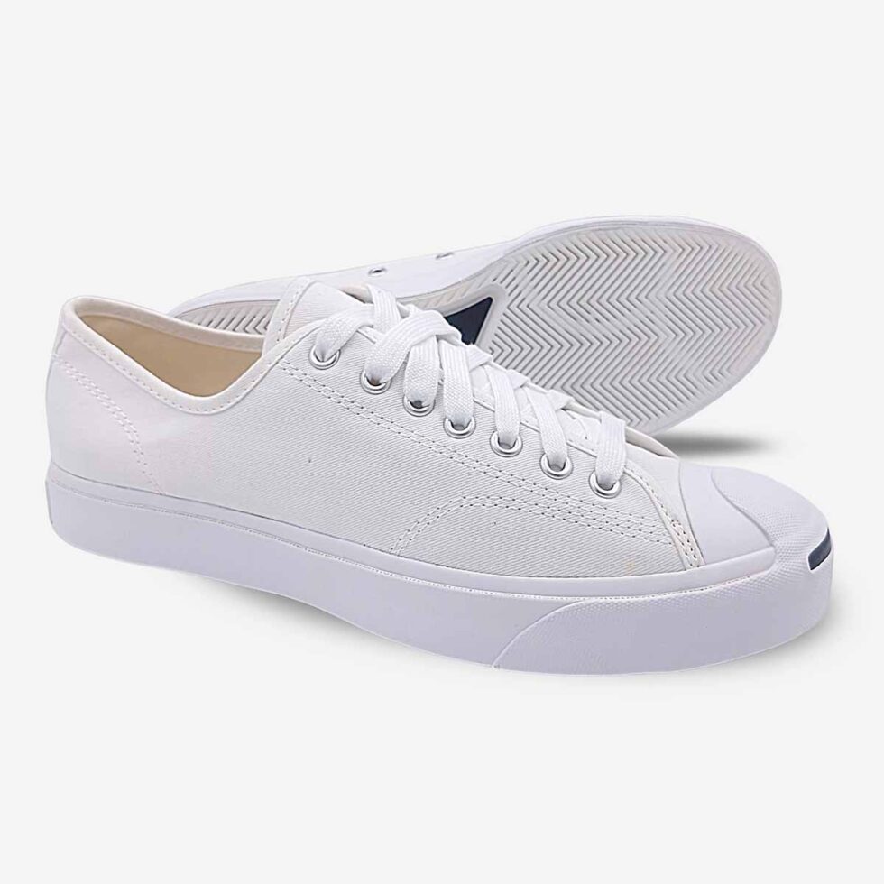 Side-bottom angle of Jack Purcell low white canvas sneakers displaying full underside of white rubber sole