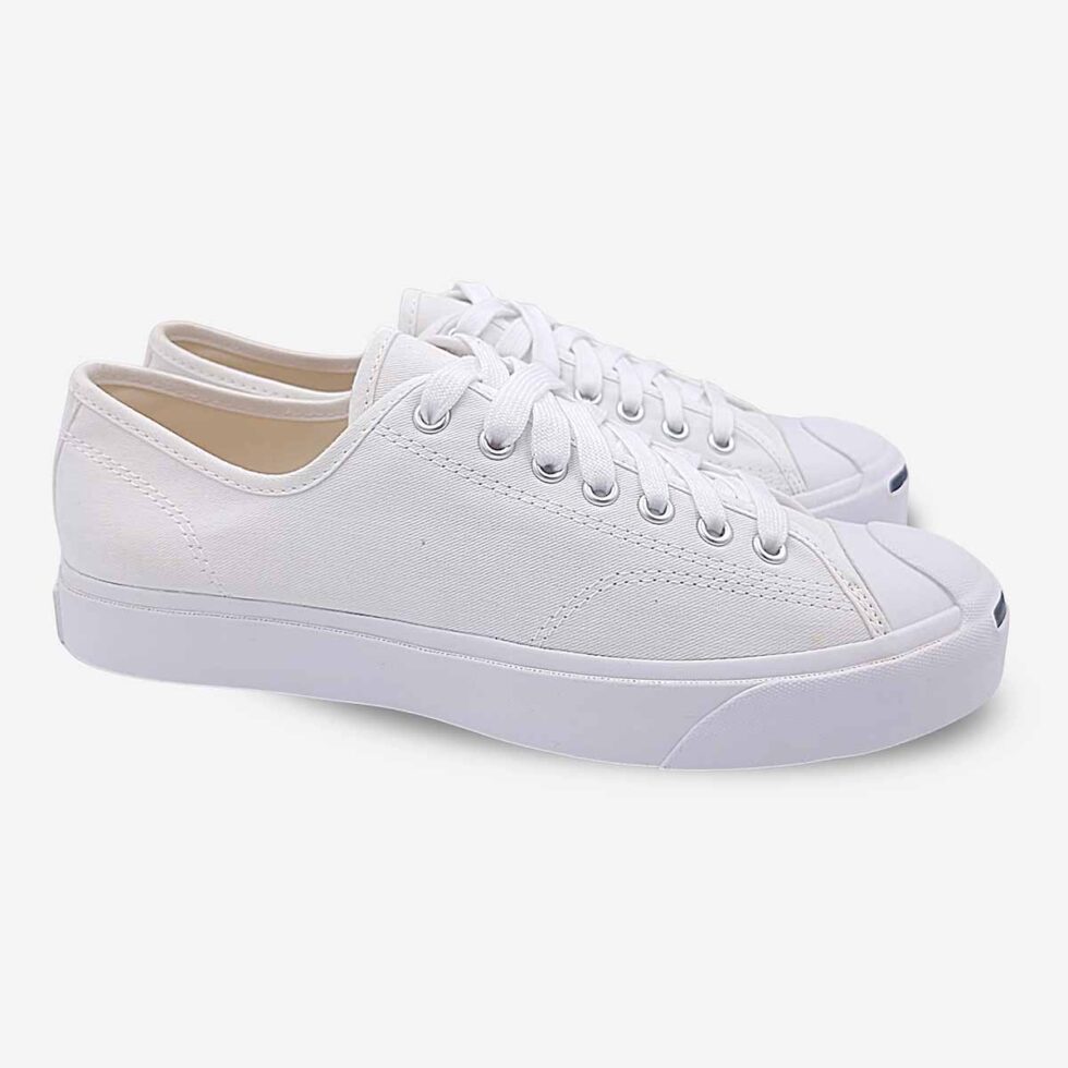 Angled pair of Jack Purcell white canvas low-top sneakers with matching white sole