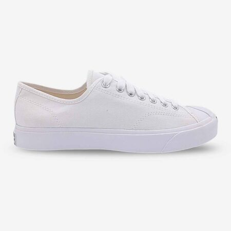 Side-front view of Jack Purcell white canvas sneaker showing lace-up design and partial view of white sole