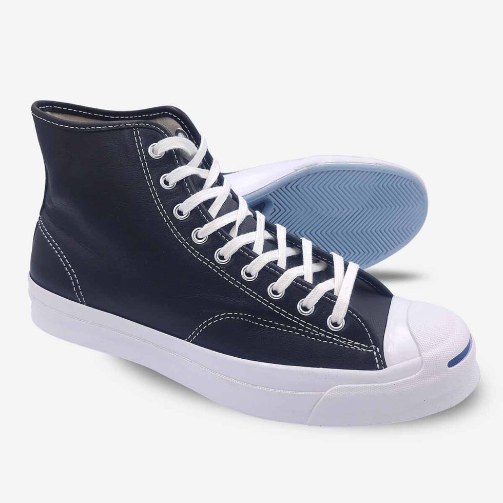 Side-bottom angle of Jack Purcell black leather high-top boots with textured rubber outsole