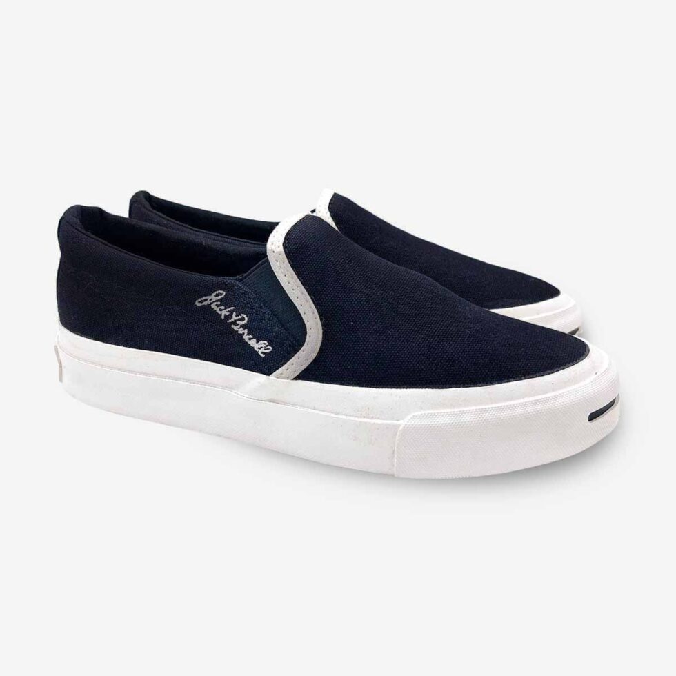 Angled pair of Jack Purcell youth black canvas slip-on sneakers