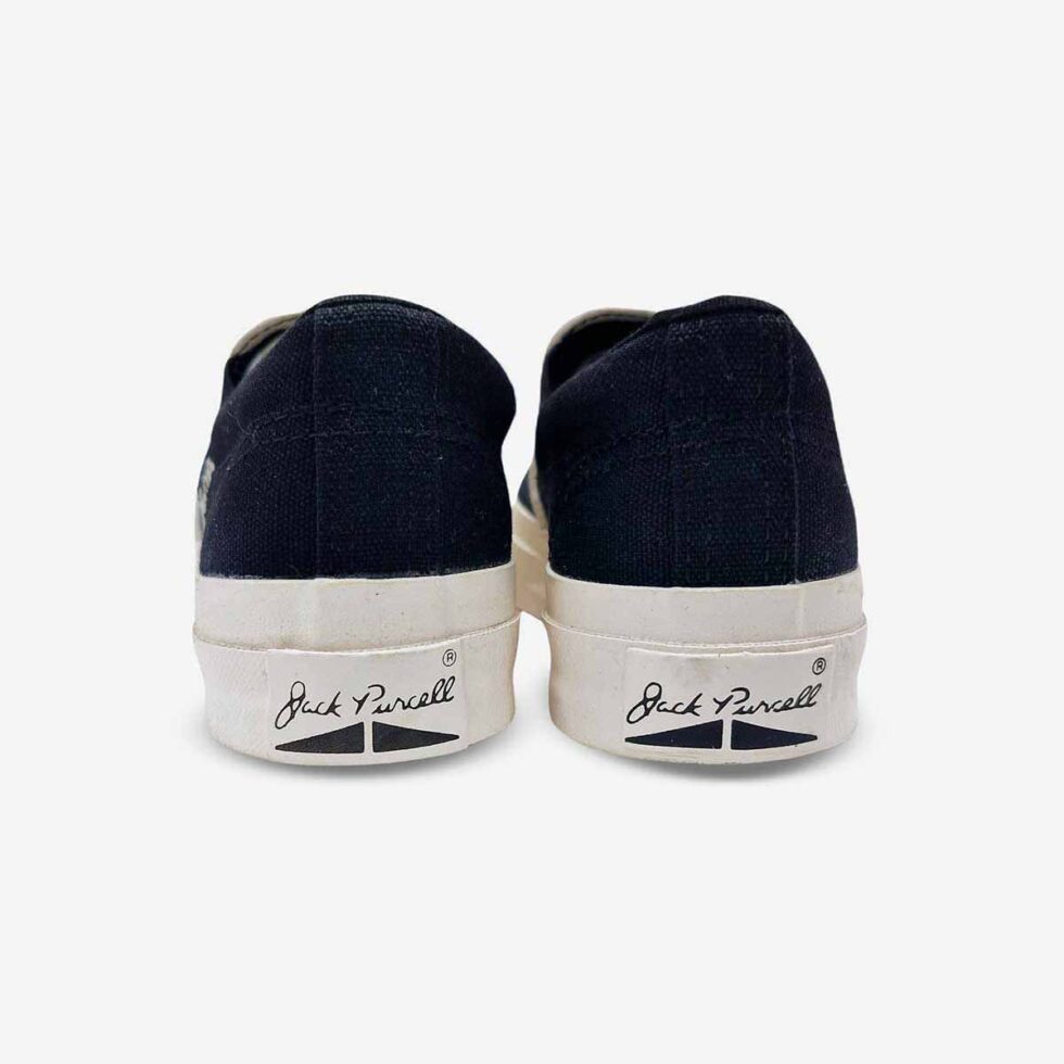 Back view of Jack Purcell youth slip-on sneaker in black showing R heel detail