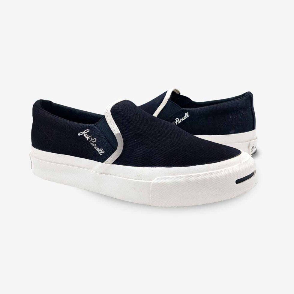 Mirrored pair of Jack Purcell youth black canvas slip-on sneakers