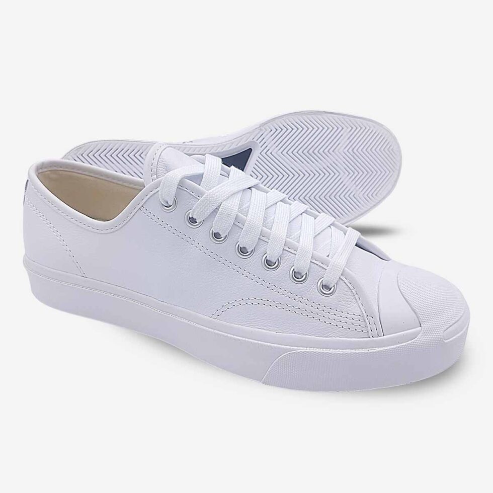 Side-bottom angle of Jack Purcell low white leather sneaker showing full rubber outsole