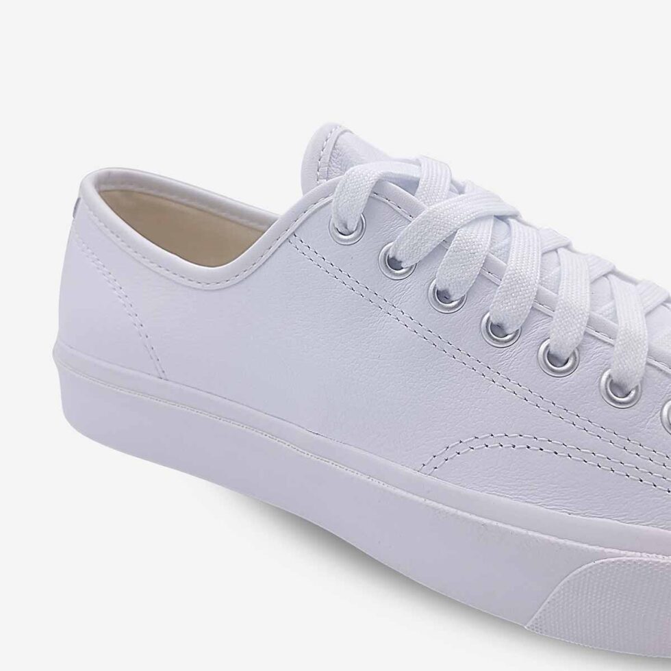 Close-up of Jack Purcell low white leather sneaker showing smooth leather and stitch detailing