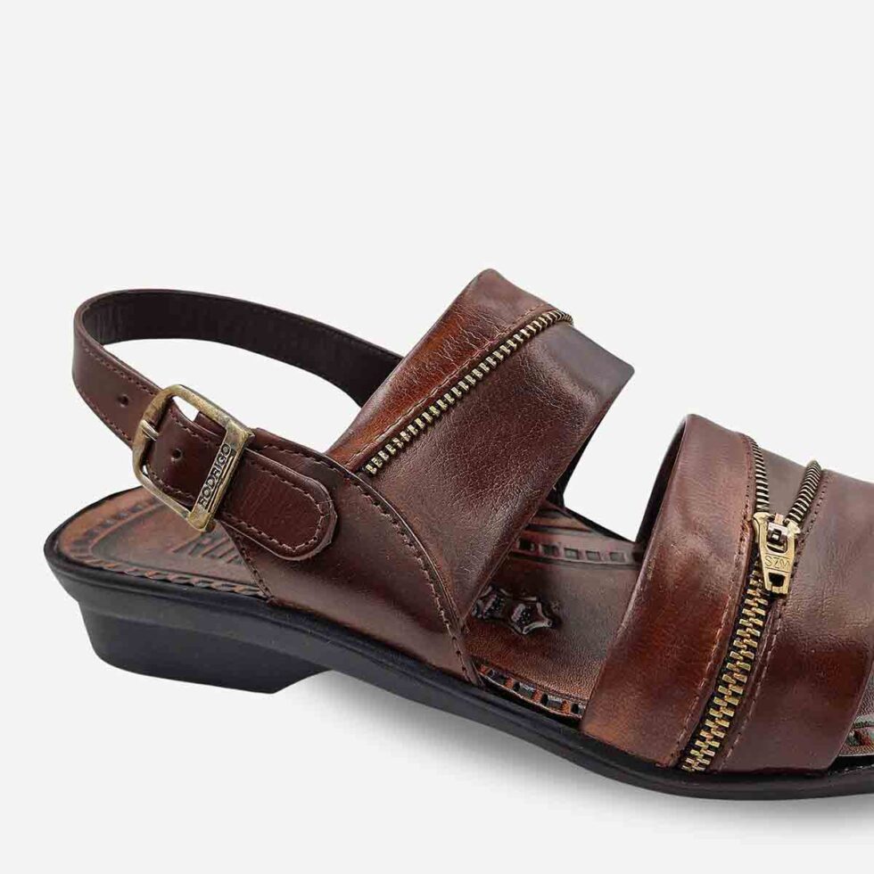 Up Close View of Rodrigo Open-Toe Sandals in Taupe showing zip-pattern detail on wave straps and stitch detailing.