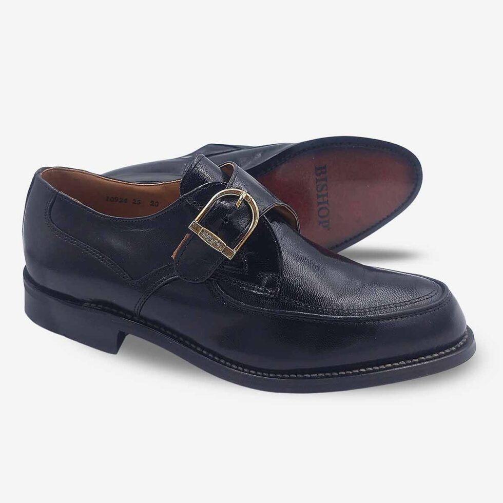 Angled pair with sole view of Bishop Monk Strap shoes in genuine textured black leather.