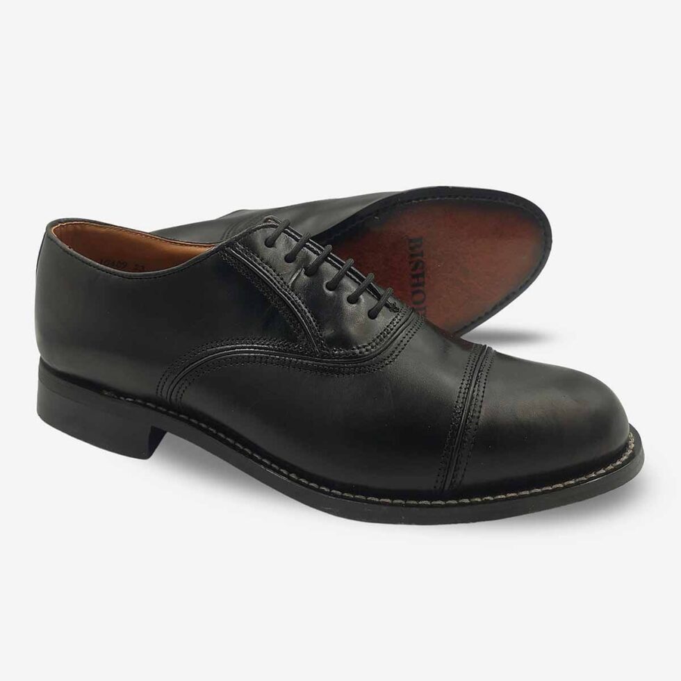 Angled pair with sole view of Bishop Oxford shoes in genuine smooth black leather with cap toe.
