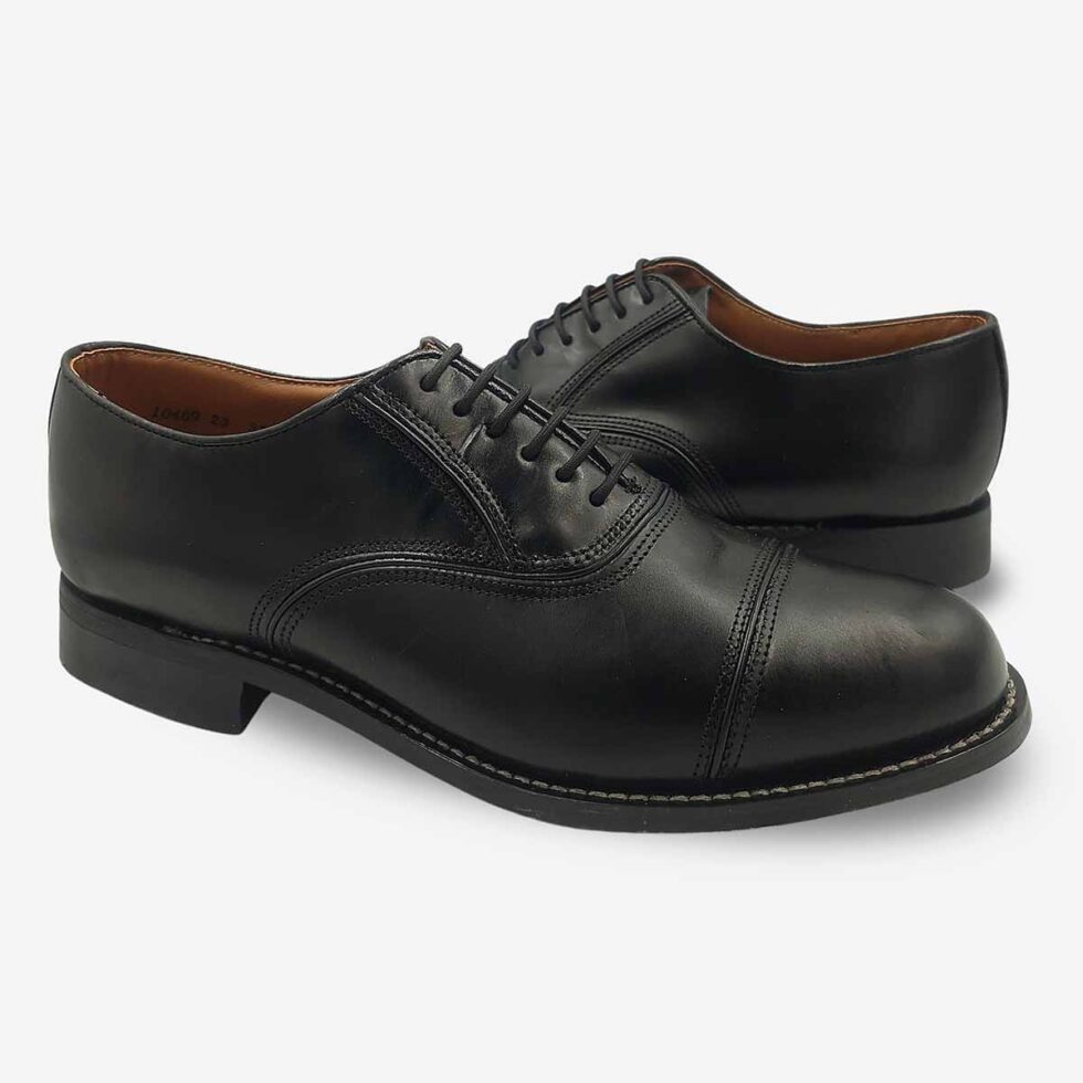 Mirrored pair of Bishop Oxford shoes in black smooth leather with cap toe.