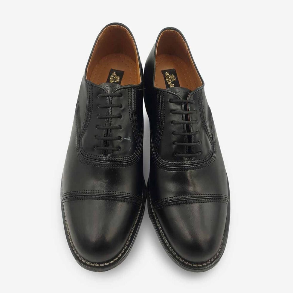 Top view of Bishop Oxford shoes in black smooth leather with cap toe detailing.