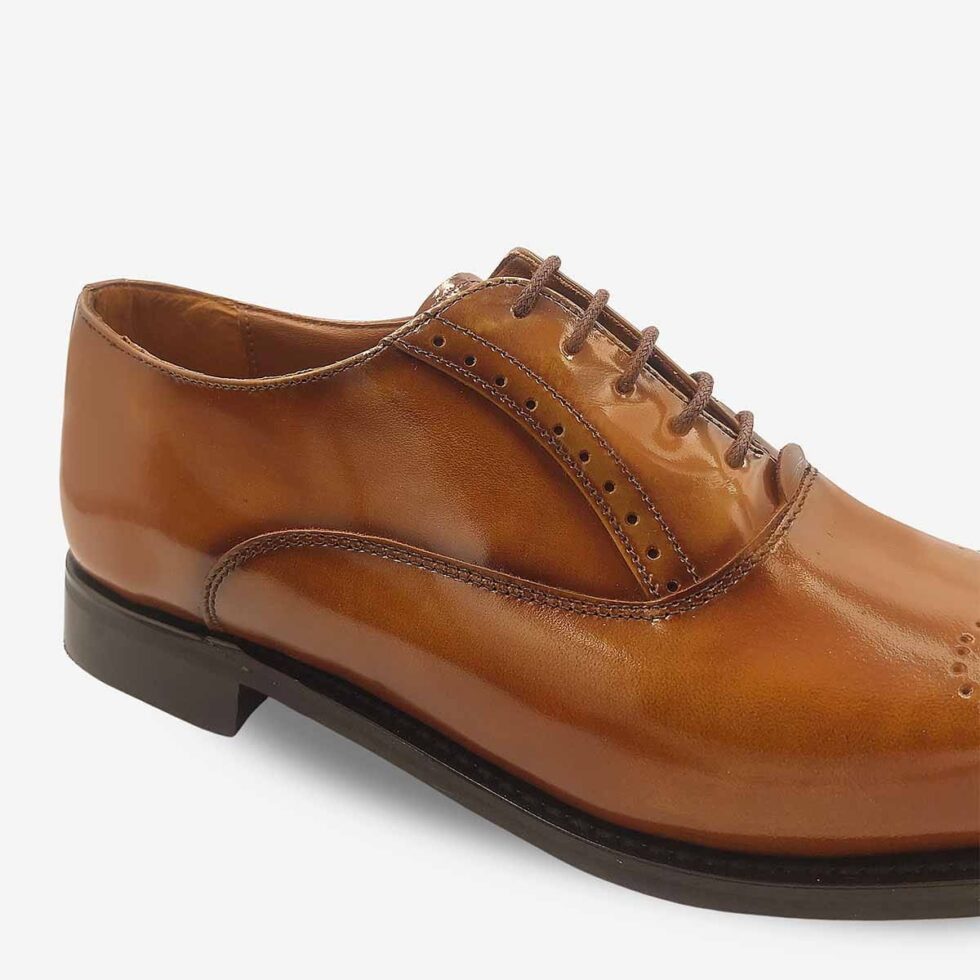Up-close view of Bishop Tan Brown Oxford Shoes with toe medallion detail.