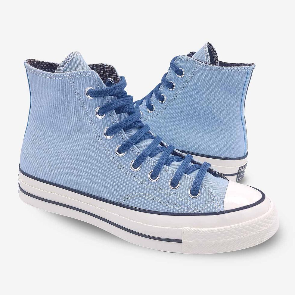 Mirrored pair of Converse Chuck 70 high-tops in sky blue colour.