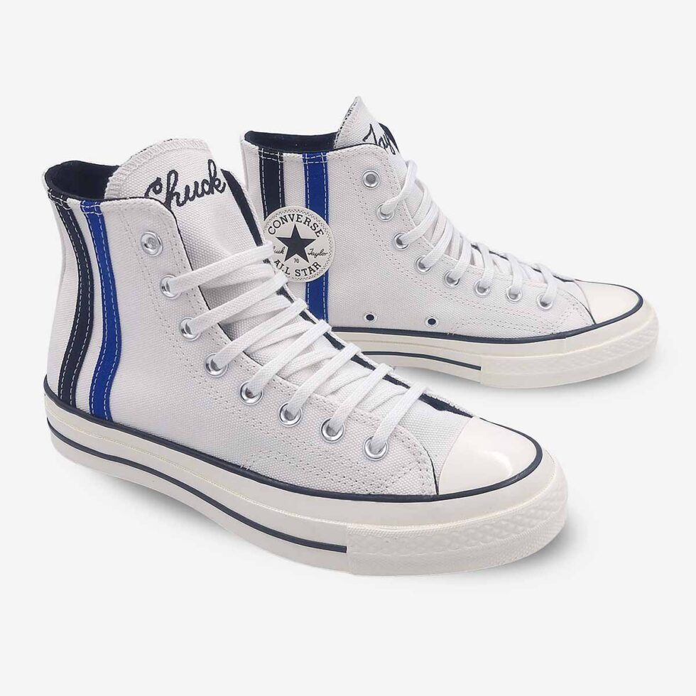 Angled view of Converse Chuck 70 Vintage White boots showing Chuck Taylor branding on tongue and black & blue ankle stripes.