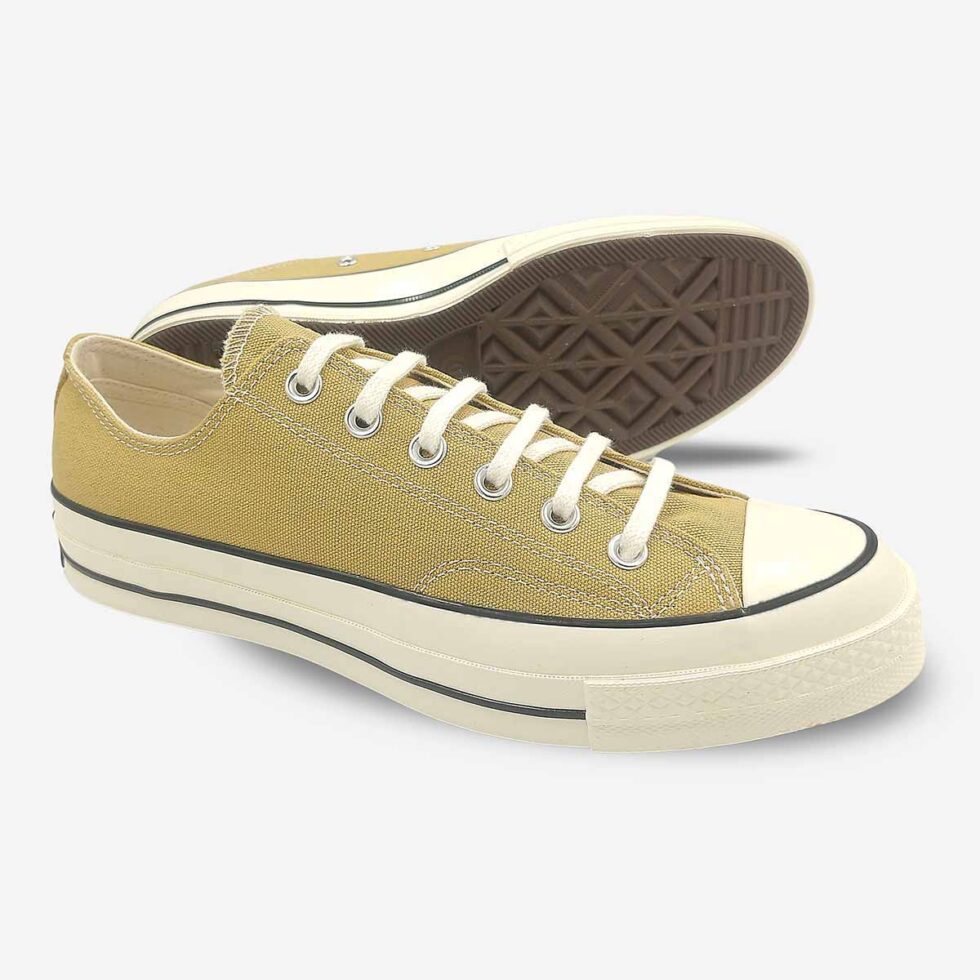 Angled pair showing sole of Converse Chuck 70 Low sneakers in a light khaki colour.