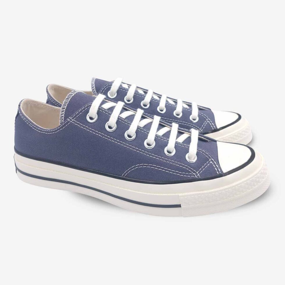 Angled pair of Converse Chuck 70 Low Navy sneakers.