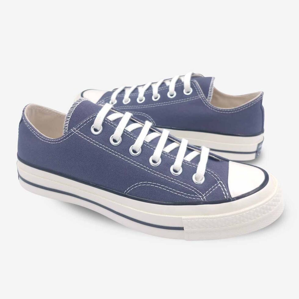 Mirrored pair of Converse Chuck 70 Low Navy sneakers.