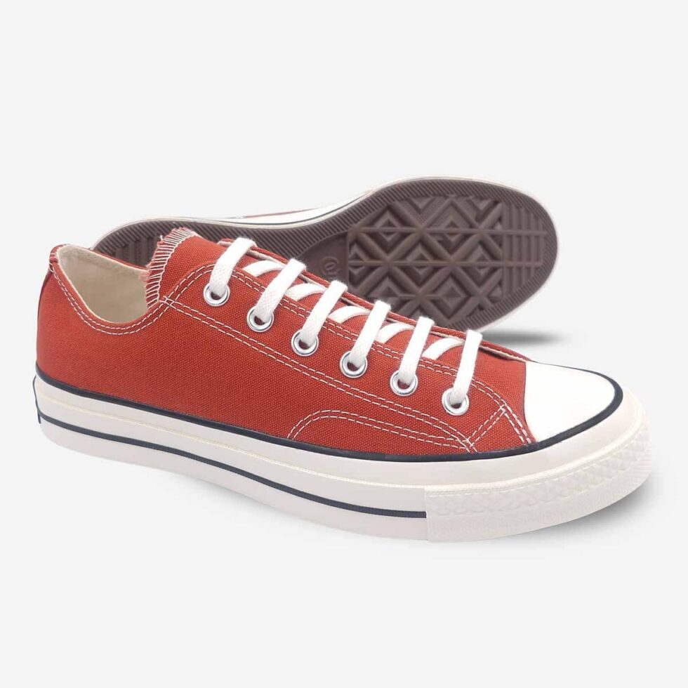 Angled pair showing sole of Converse Chuck 70 Low Red sneakers.