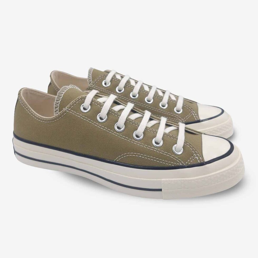 Angled pair of Converse Chuck 70 Low sneakers in a taupe brown colour.
