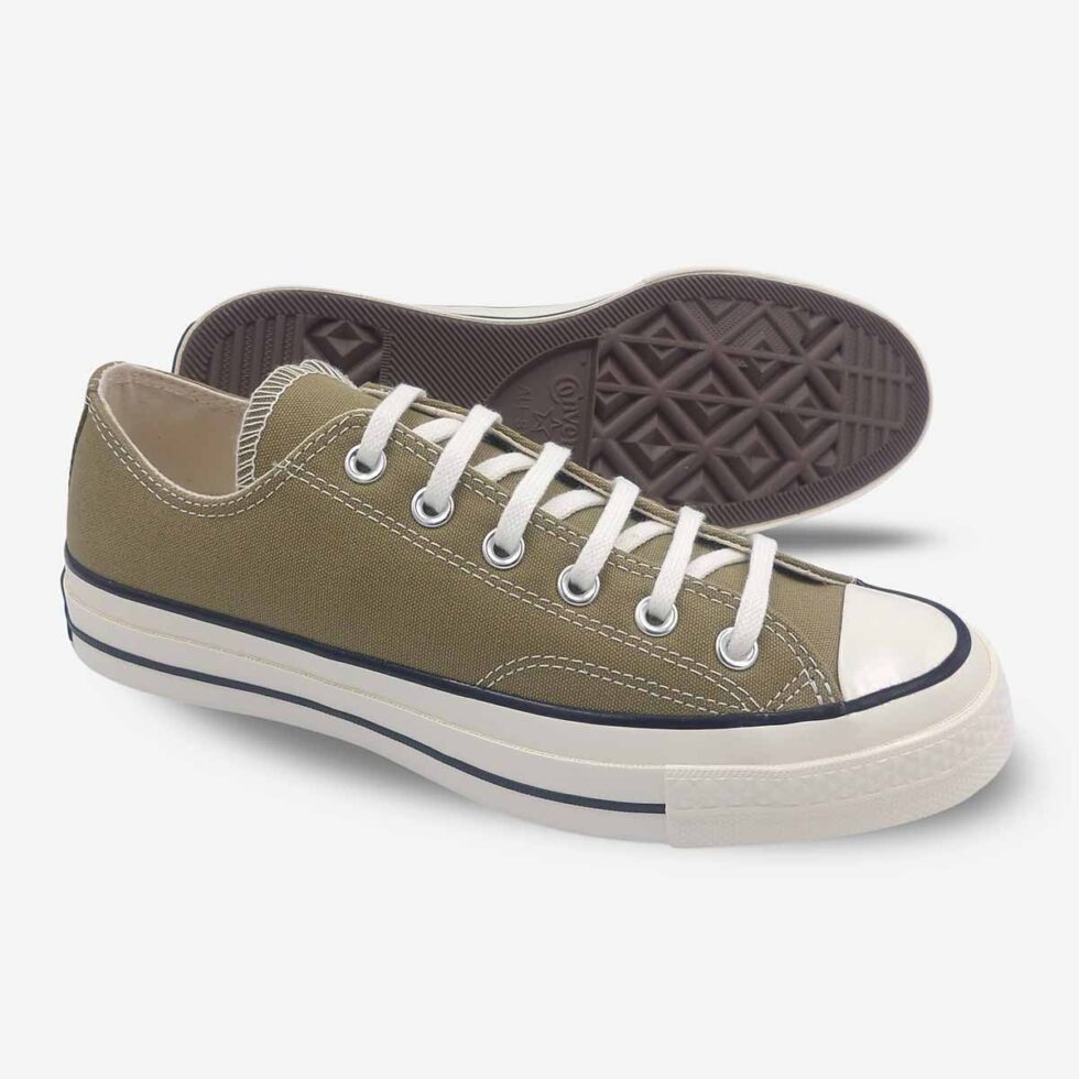 Angled pair showing sole of Converse Chuck 70 Low sneakers in a taupe brown colour.