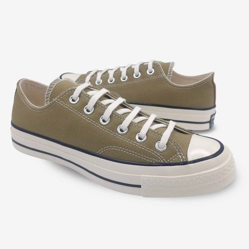 Mirrored pair of Converse Chuck 70 Low sneakers in a taupe brown colour.
