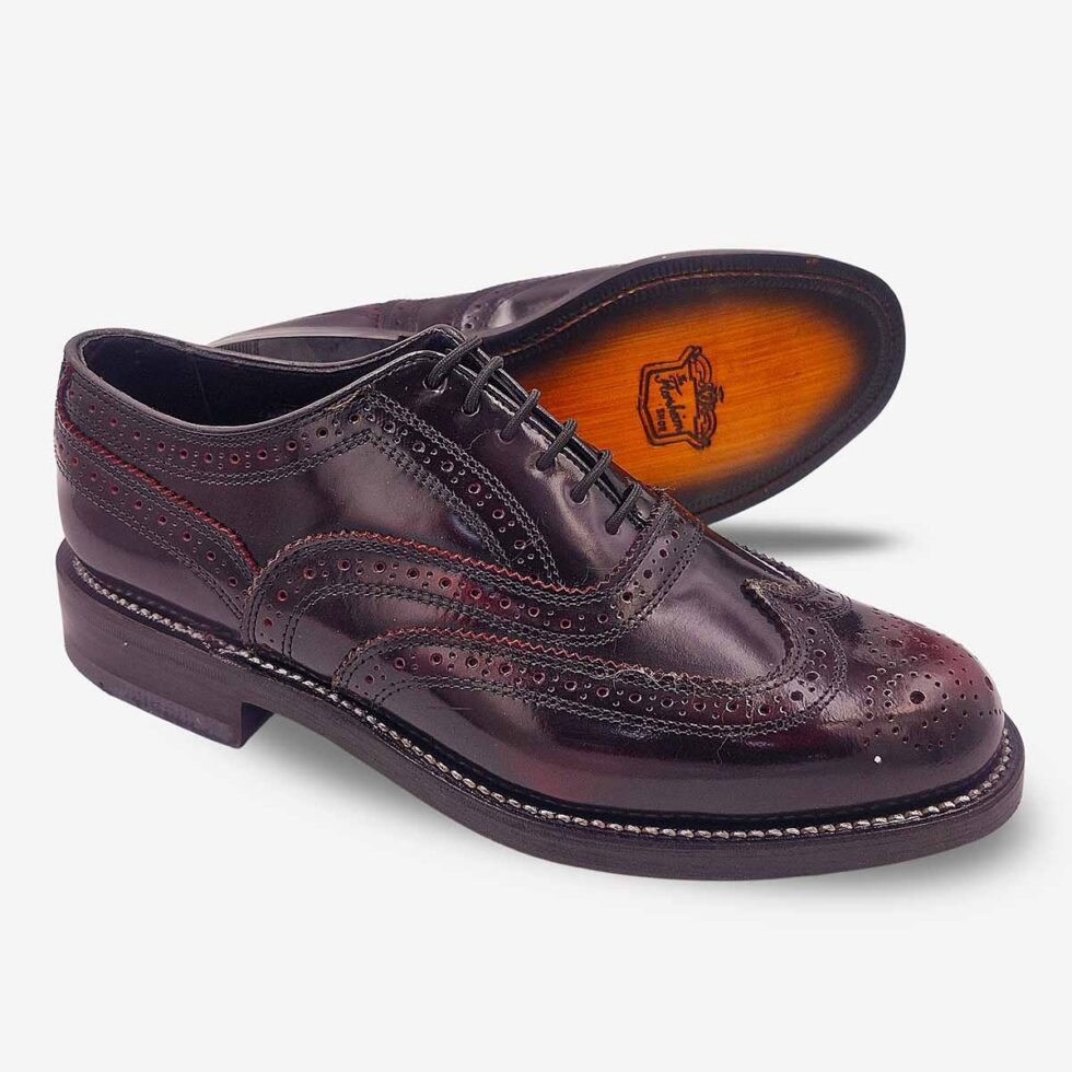 Angled pair showing sole of Florsheim Cobbler Wingtip Shoes in burgundy.