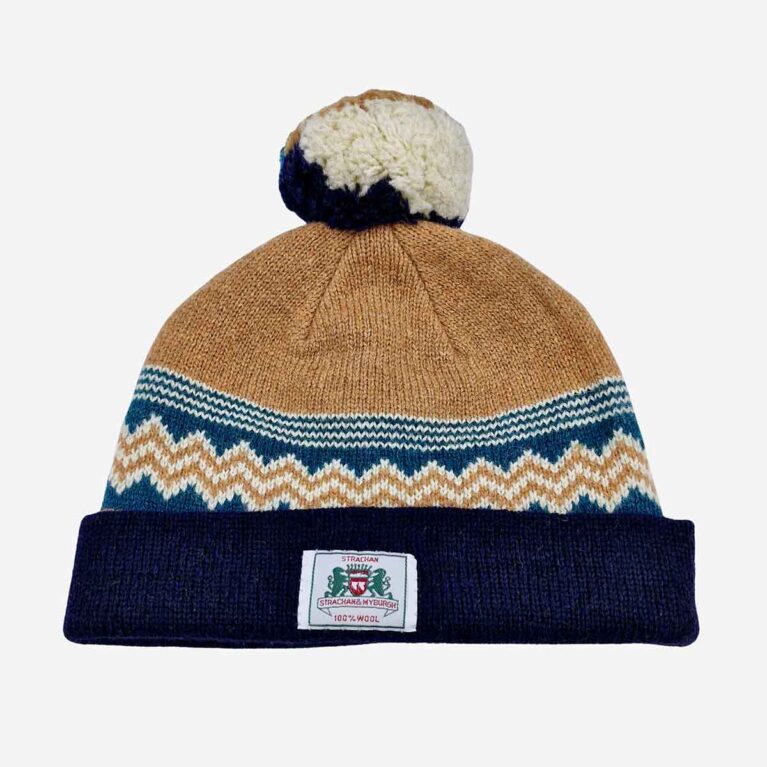 Top view of Strachan zigzag wool beanie in light brown, turquoise and navy blue with front logo tab