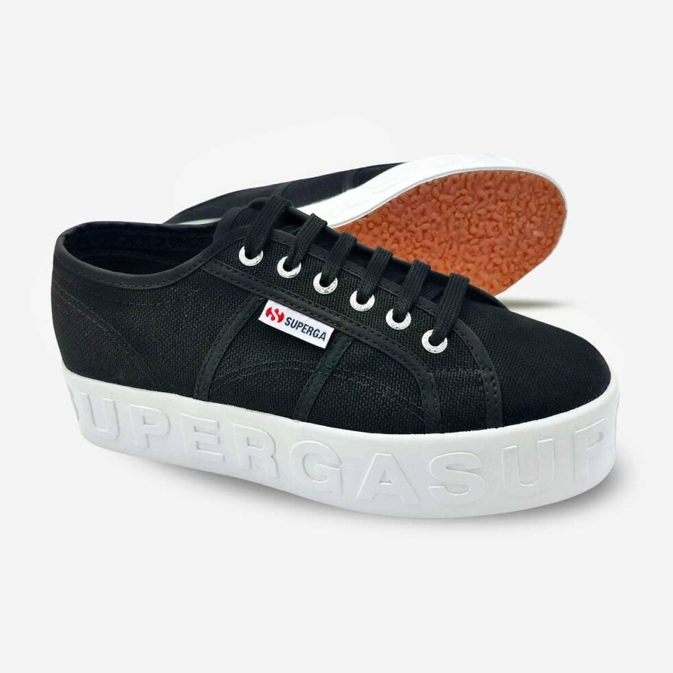 Black Superga 2790 platform sneakers, angled pair showing rubber sole with raised white 3D lettering